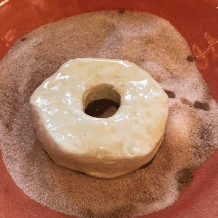 Golden air fryer biscuit donuts cooking in an Instant Vortex Plus basket in a single layer