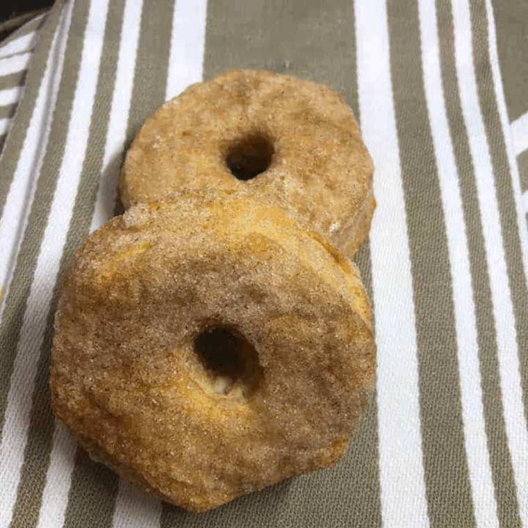 Cinnamon sugar air fryer donut holes piled in a bowl, made from canned biscuit centers