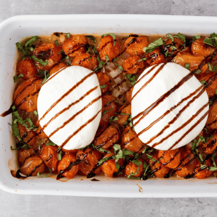 Sprinkle fresh basil over tomatoes, season with salt and pepper, top with burrata, drizzle with balsamic glaze, and serve with crostinis.