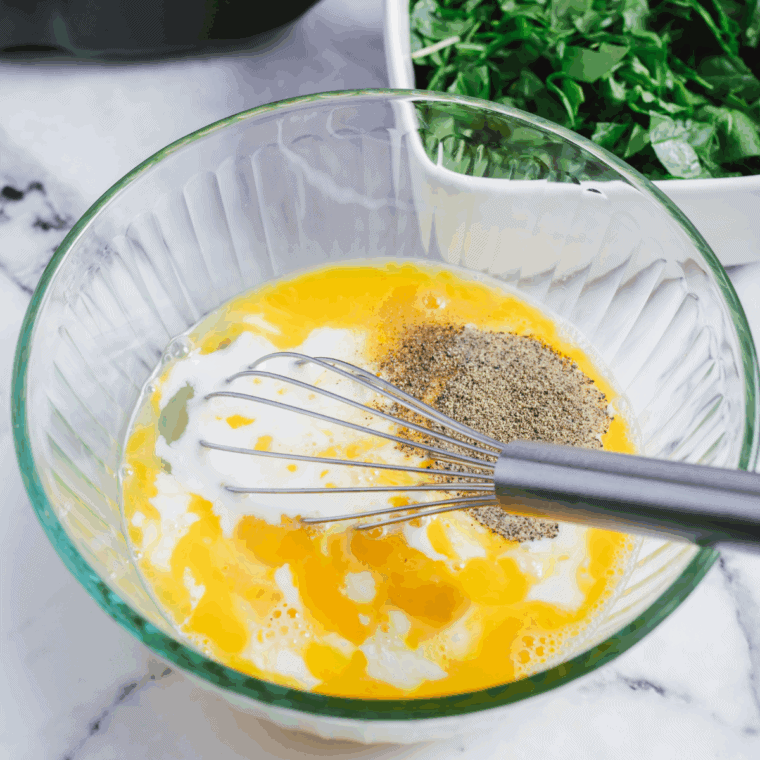 Whisk eggs, milk, salt, and pepper in a bowl, preheating air fryer to 400°F.