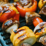 Marinated beef kabobs with peppers and onions on skewers