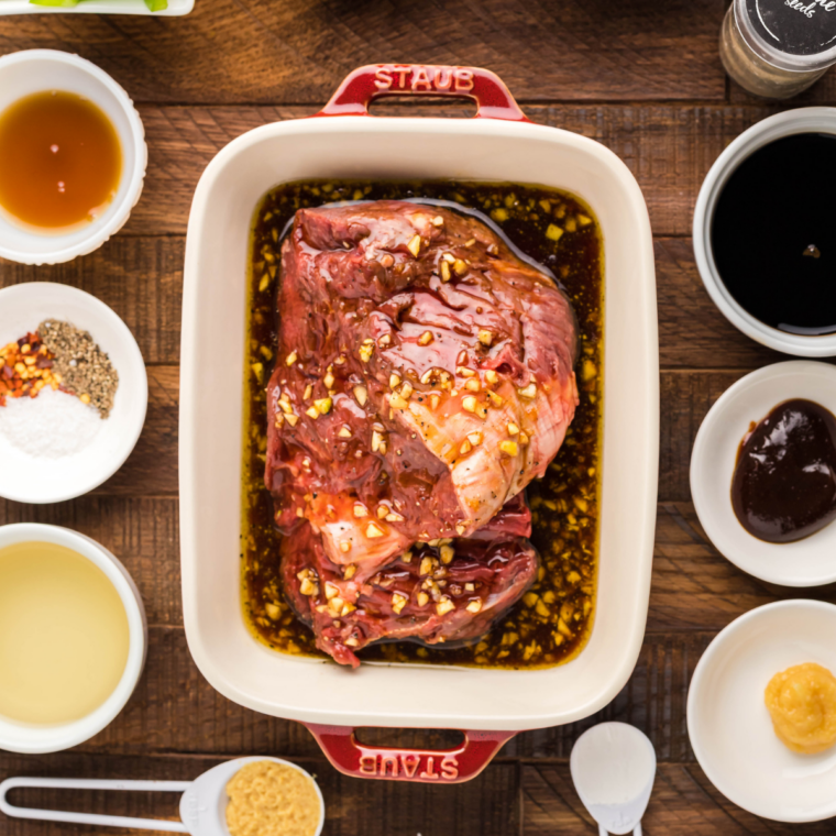 Cubed sirloin steak added to beef kabob marinade in a bowl