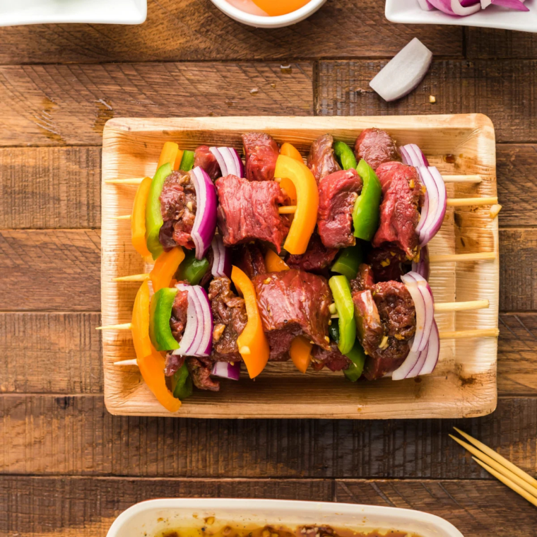 Whisking beef kabob marinade ingredients together in a bowl