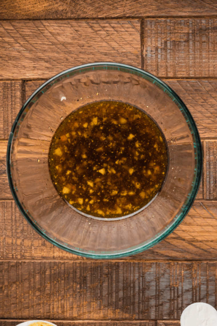 Whisking Worcestershire, soy sauce, balsamic vinegar, and spices into beef kabob marinade in a bowl