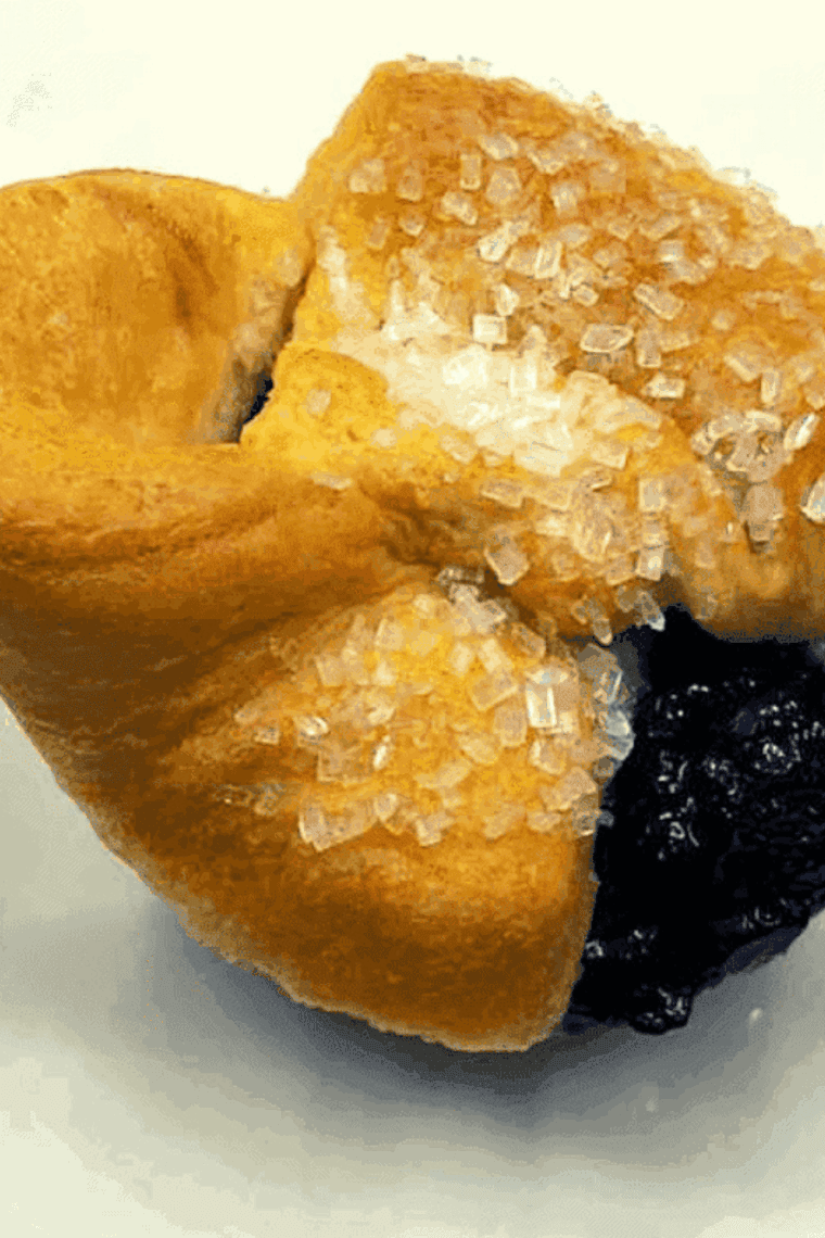 Freshly baked air fryer blueberry crescent roll muffins with golden flaky layers and juicy blueberry filling.