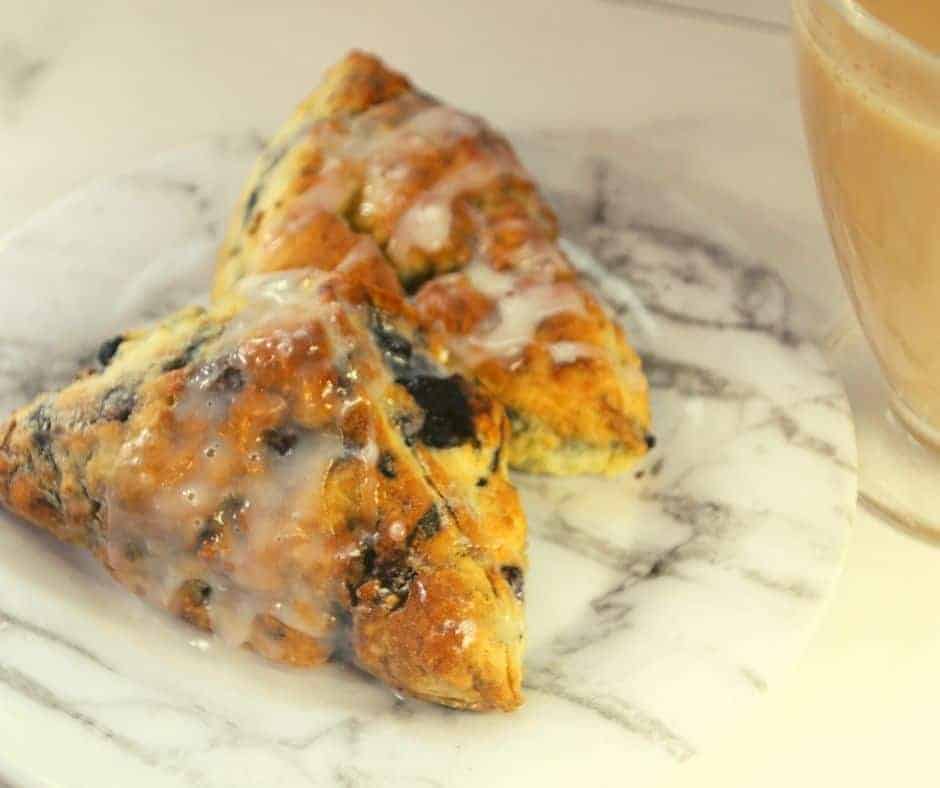 A warm scone served with a light glaze, soft and golden inside