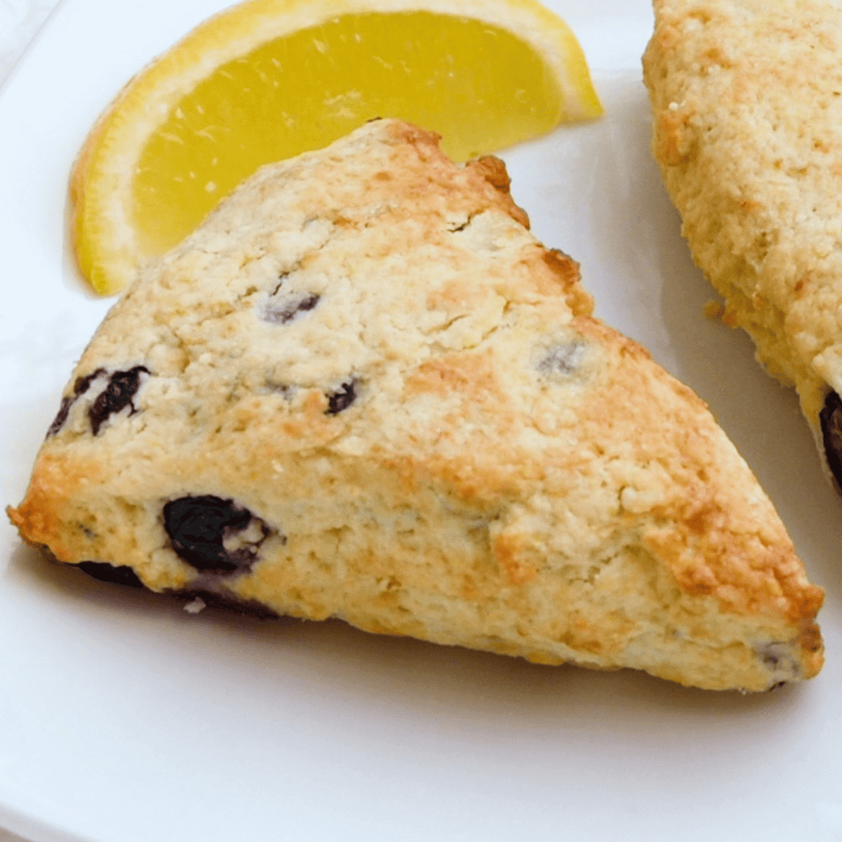 Stack of warm scones with a crisp golden crust and tender, fruit-studded centers