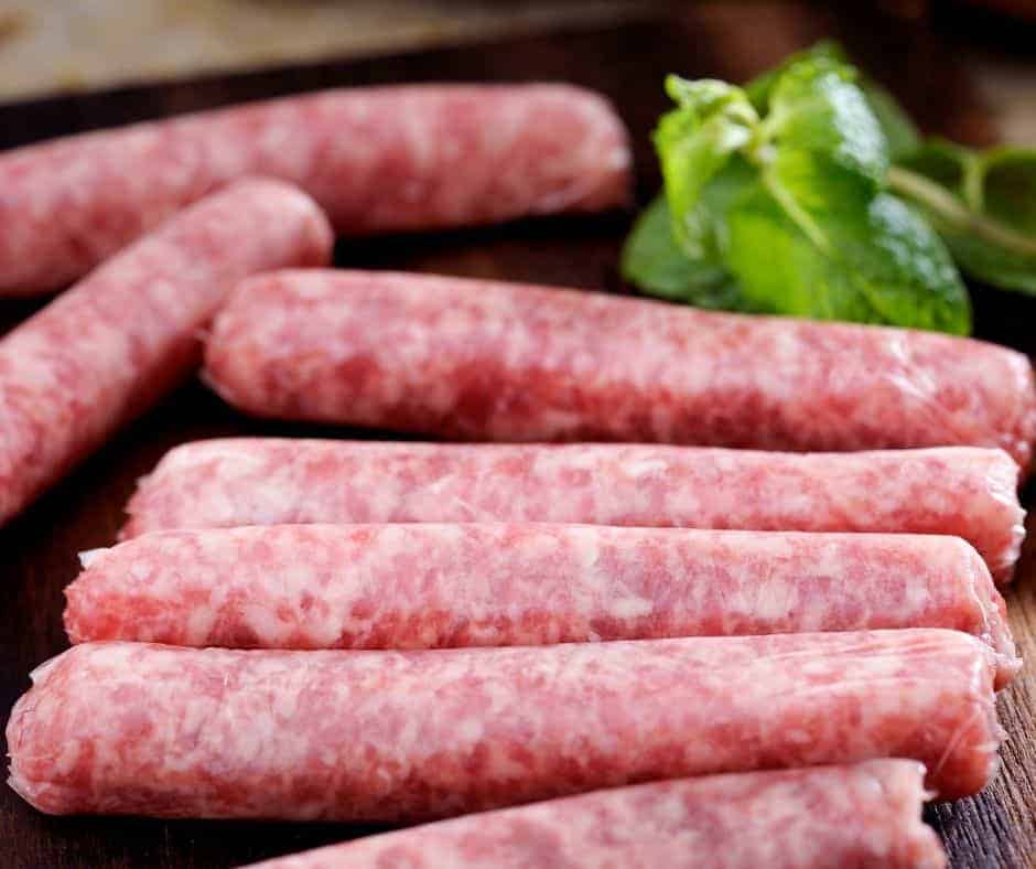 uncooked breakfast sausage links on kitchen table.