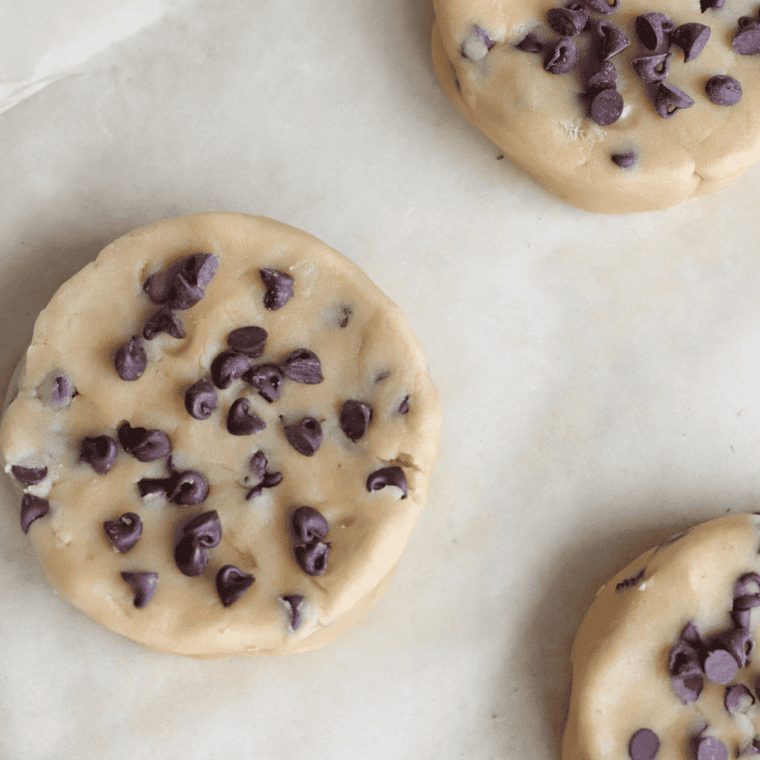 Air fryer with cookie dough cooking at 320°F, cookies beginning to brown.