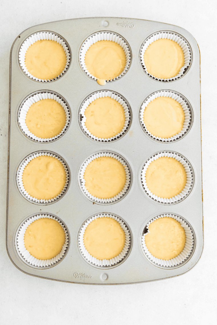 Fill the Cups – Pouring batter into muffin cups, filling about two-thirds full.
