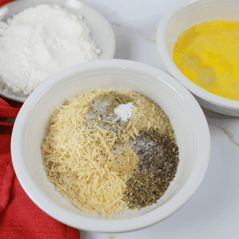 Mixing Parmesan cheese, Panko breadcrumbs, and seasonings in a shallow bowl.