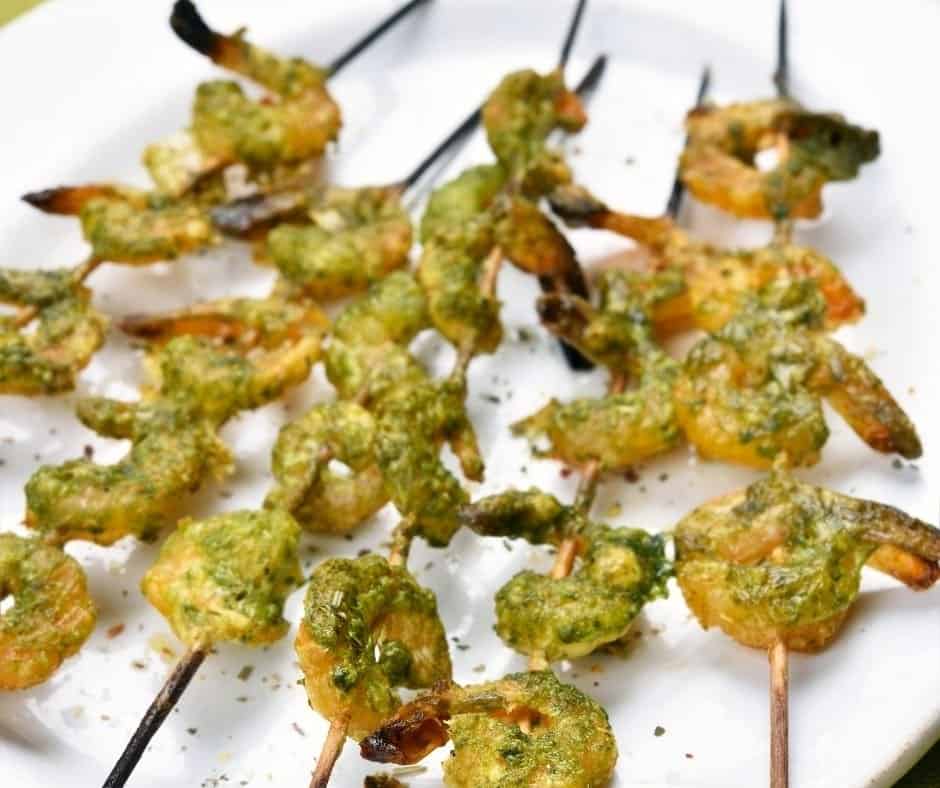 Pour in the basil pesto sauce and mix well, covering the shrimp As you thread them through the skewer, place them on a greased air fryer oven sheet or in a greased air fryer basket. Place in the air fryer oven or basket and set the temperature to 400 degrees F for 5 minutes. Once they are opaque in color pull them out, as you don't want them to overcook. Plate, serve and enjoy!