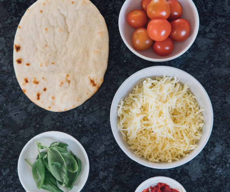 Ingredients needed for Panera Margherita Flatbread Pizza Recipe on kitchen table.