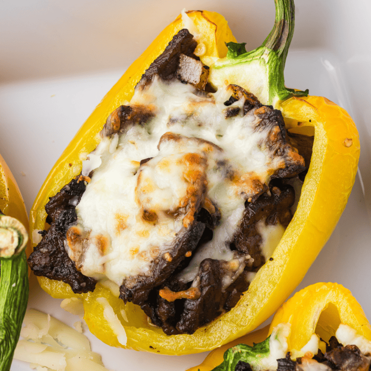 Air Fryer Philly Cheesesteak Stuffed Peppers with melted cheese, sautéed onions, and tender steak in roasted bell peppers.