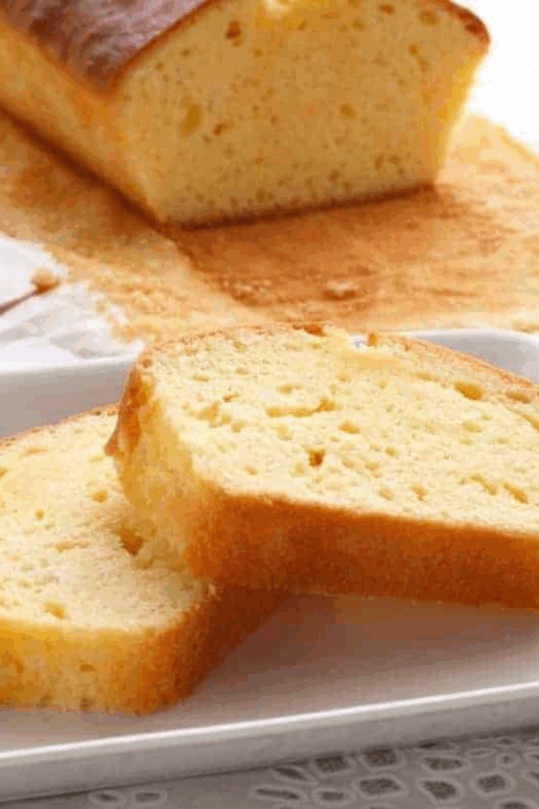 Slice of Easy Ina Garten’s Pound Cake on a white plate, showing golden crust and moist interior.