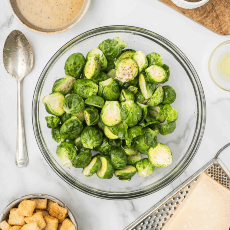 Ingredients for copycat Longhorn Brussels sprouts: halved sprouts, olive oil, butter, honey, maple syrup, paprika, and chili