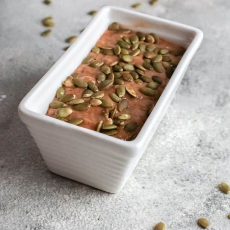 Chocolate chip pumpkin bread batter poured into a greased loaf pan