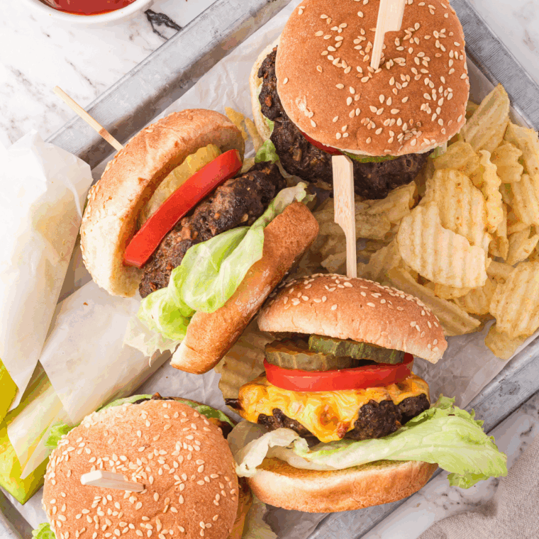 Homemade copycat A&W Buddy Burger with beef patty, pickles, and sauce.