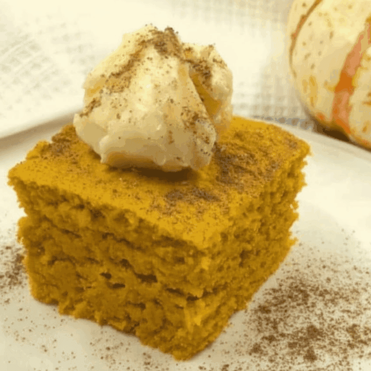 Slice of Easy Air Fryer Pumpkin Cornbread, golden brown with a soft, fluffy texture and autumn spices.
