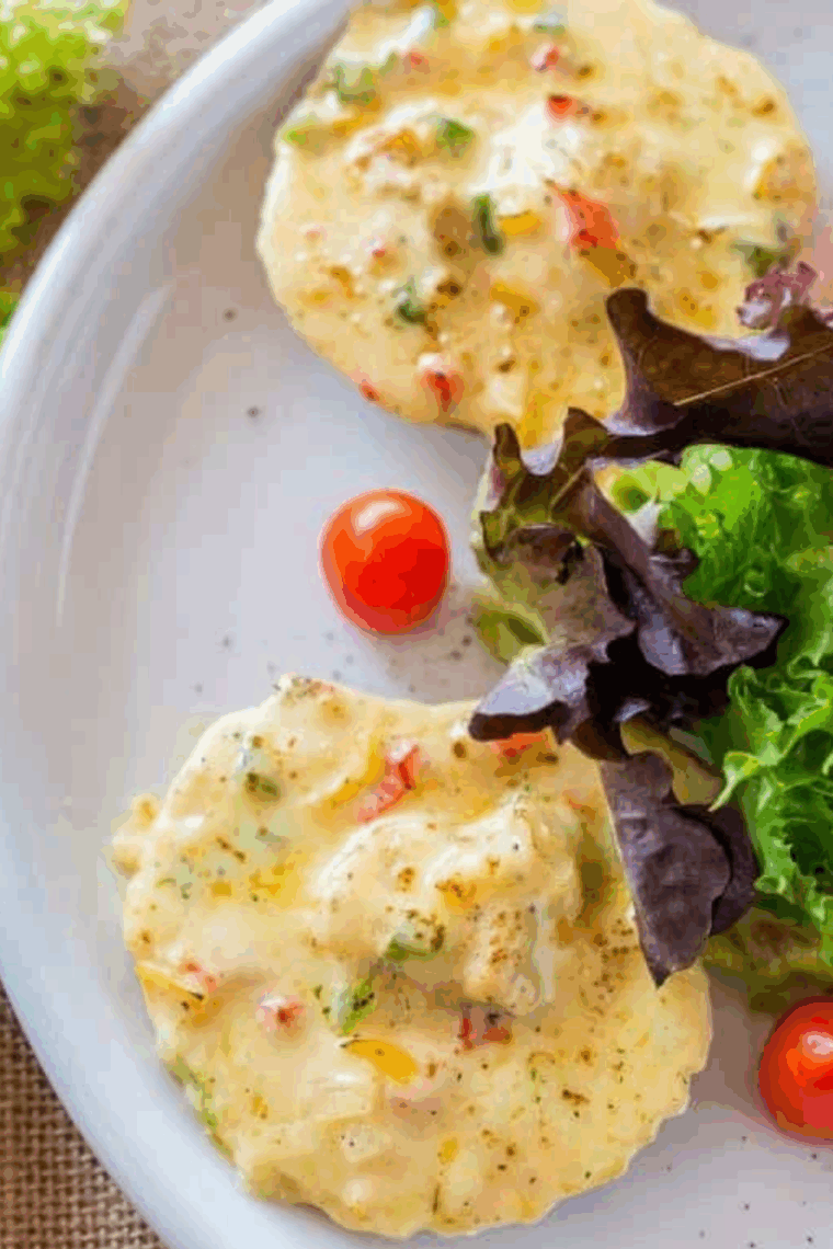 Golden air fryer scallops served on the half shell with fresh herbs