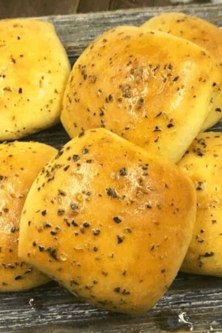Golden, fluffy Bob Evan's-type dinner rolls baked just now on a plate.