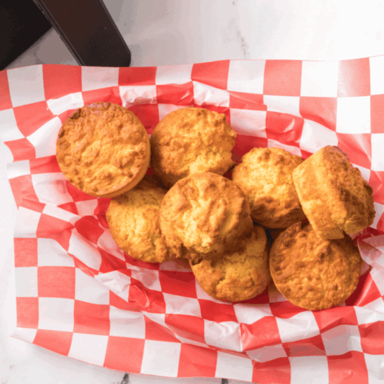 Warm, homemade Cracker Barrel-type cornbread muffins, golden brown and presented in a plate.