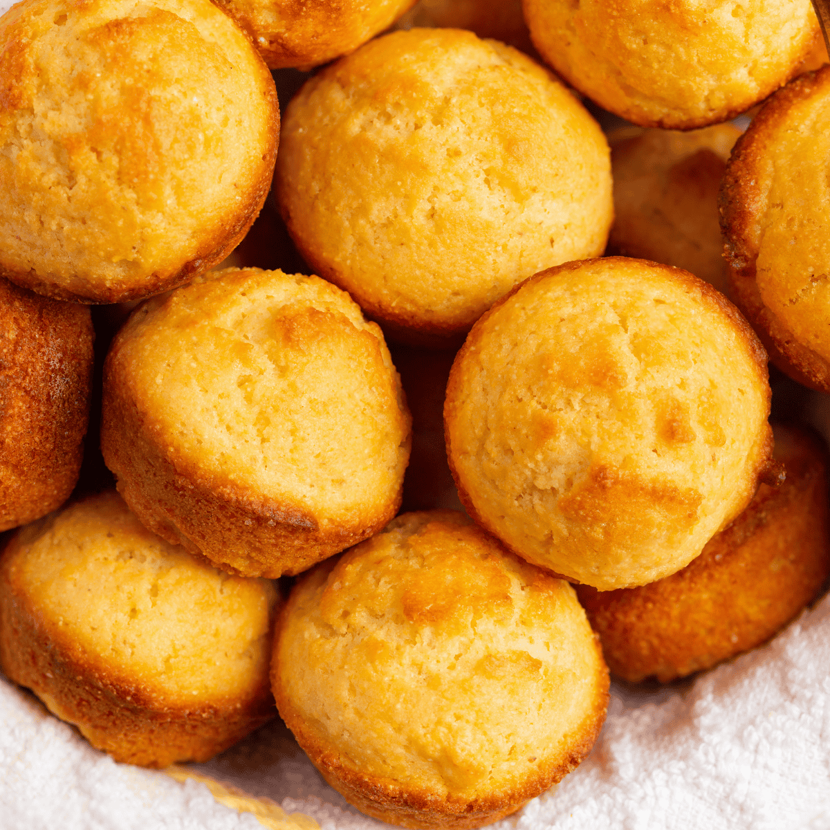 Golden Cracker Barrel cornbread muffins on a plate, served warm and ready to eat.