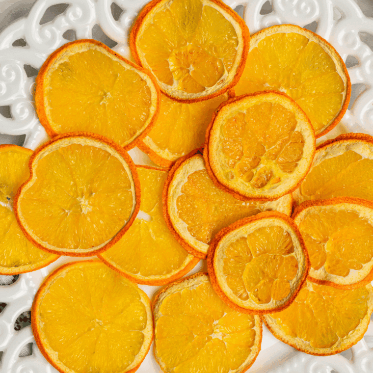 Removing fully dehydrated orange slices from the air fryer and letting them cool completely before storing.