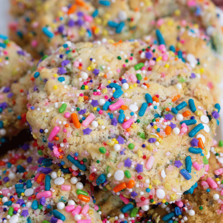 Soft, golden confetti cookies fresh from the air fryer, filled with colorful sprinkles.