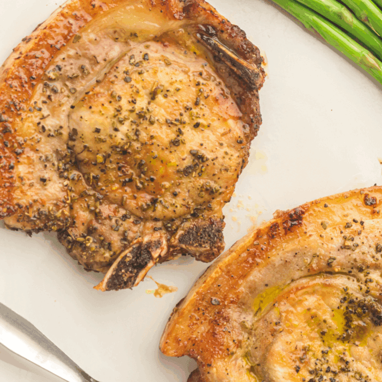 Golden-brown TGI Fridays-style Pepper Crusted Pork Chops with a crispy, flavorful pepper crust, served on a plate