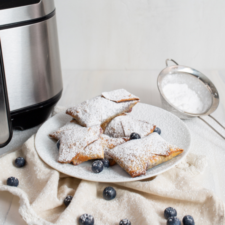 Air fryer blueberry egg roll cut open showing warm blueberry filling