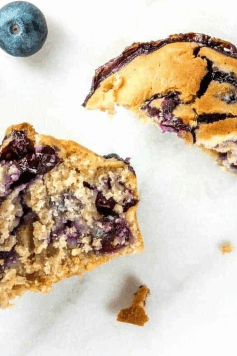 Single air fryer blueberry muffin with golden top and juicy blueberries, freshly baked and ready to enjoy.