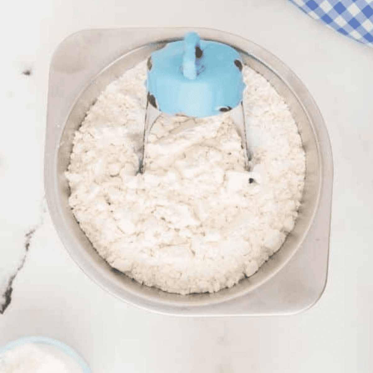 Mixing flour, salt, sugar, baking powder, butter, eggs, cream, and vanilla in a large bowl to make scone dough.