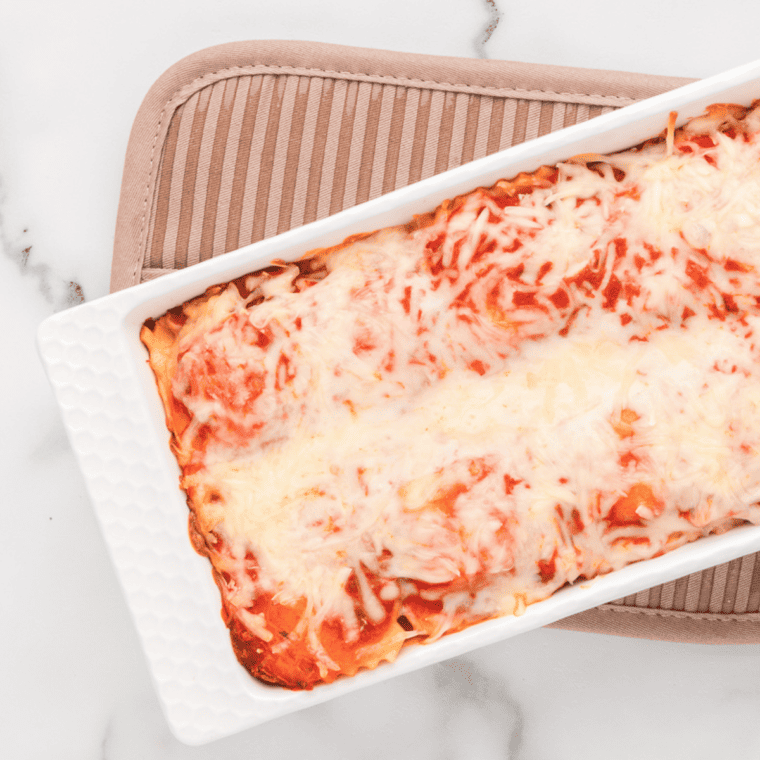 Layered Air Fryer Ravioli Lasagna with melted cheese and marinara sauce.
