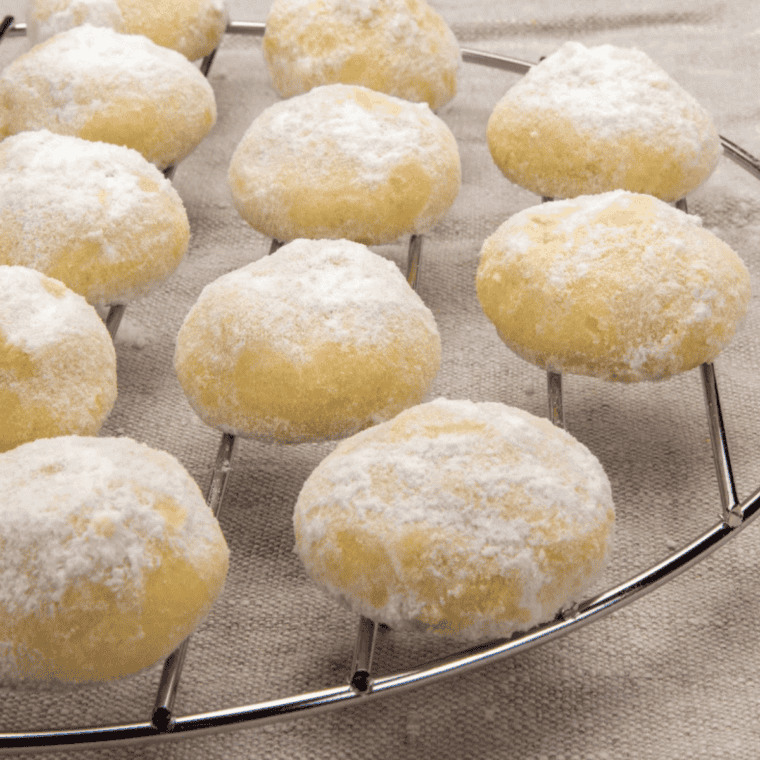 Golden Russian Tea Cakes fresh from the air fryer, coated in powdered sugar and ready to serve.
