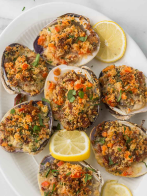 Golden air fryer stuffed clams (quahogs) served in the shell with lemon wedges