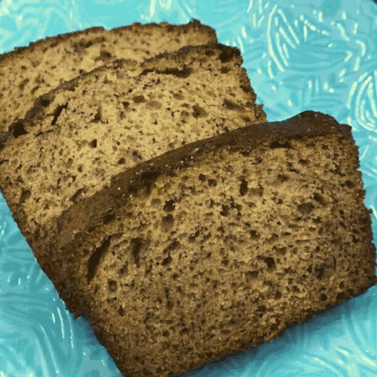 Loaf of Easy Banana Bread made with shortening, showing golden-brown crust and soft, moist interior.