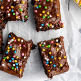 Plate of fudgy Ninja Crispi brownies topped with chocolate frosting and sparkles