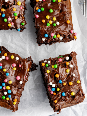 Plate of fudgy Ninja Crispi brownies topped with chocolate frosting and sparkles