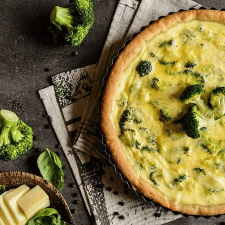 Golden slice of Air Fryer Broccoli and Cheddar Cheese Quiche on a plate