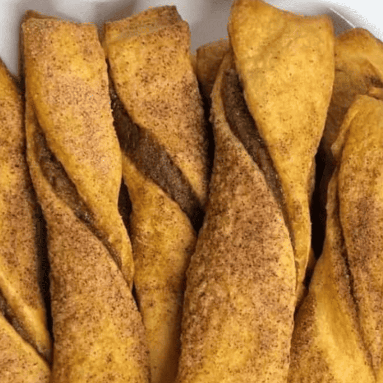Why You’ll Love Air Fryer Cinnamon Sugar Twists
You'll fall in love with Air Fryer Cinnamon Sugar Twists for several delightful reasons:
Irresistible Flavor: These twists are coated in a sweet and aromatic cinnamon sugar mixture that creates a mouthwatering combination of flavors reminiscent of your favorite cinnamon rolls.
Flaky and Crunchy: The magic of the air fryer transforms the pastry into a golden-brown, flaky, and crispy delight on the outside while maintaining a tender interior.
Quick and Easy: Making cinnamon sugar twists in the air fryer is incredibly fast and hassle-free, saving you time and effort compared to traditional baking methods.
Minimal Mess: Air frying keeps your kitchen clean and minimizes the mess of using a deep fryer or baking in the oven.
Customizable: You can customize these twists by adding extra nuts, chocolate chips, or a drizzle of icing to suit your taste preferences.
Perfect for Any Time: Enjoy them as a delectable breakfast, a sweet snack, or a dessert. They're versatile and suitable for any occasion.
Kid-Friendly: Loved by both children and adults, these twists are a family-friendly treat that's sure to please everyone.
No Oven Required: If you don't have access to an oven or want to avoid heating up your kitchen, the air fryer is a convenient alternative for baking.
Satisfies Cravings: When you're craving something sweet and crunchy, Air Fryer Cinnamon Sugar Twists are the perfect solution.
Endless Variations: You can experiment with different toppings, fillings, or glazes to create your own signature twists.
In summary, Air Fryer Cinnamon Sugar Twists offer the perfect balance of convenience and indulgence, making them an irresistible treat that will become a household favorite.