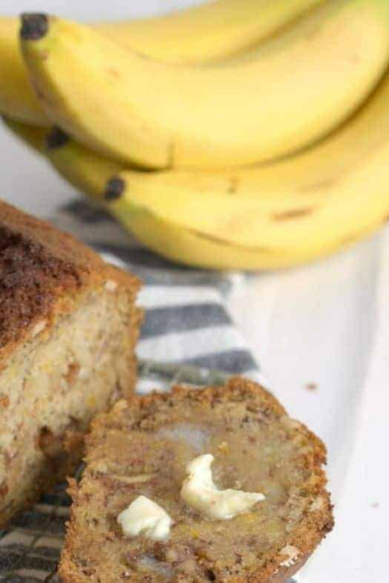 Sliced air fryer gluten-free banana bread on a wooden cutting board