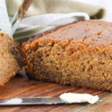 Sliced air fryer gluten-free banana bread on a wooden cutting board