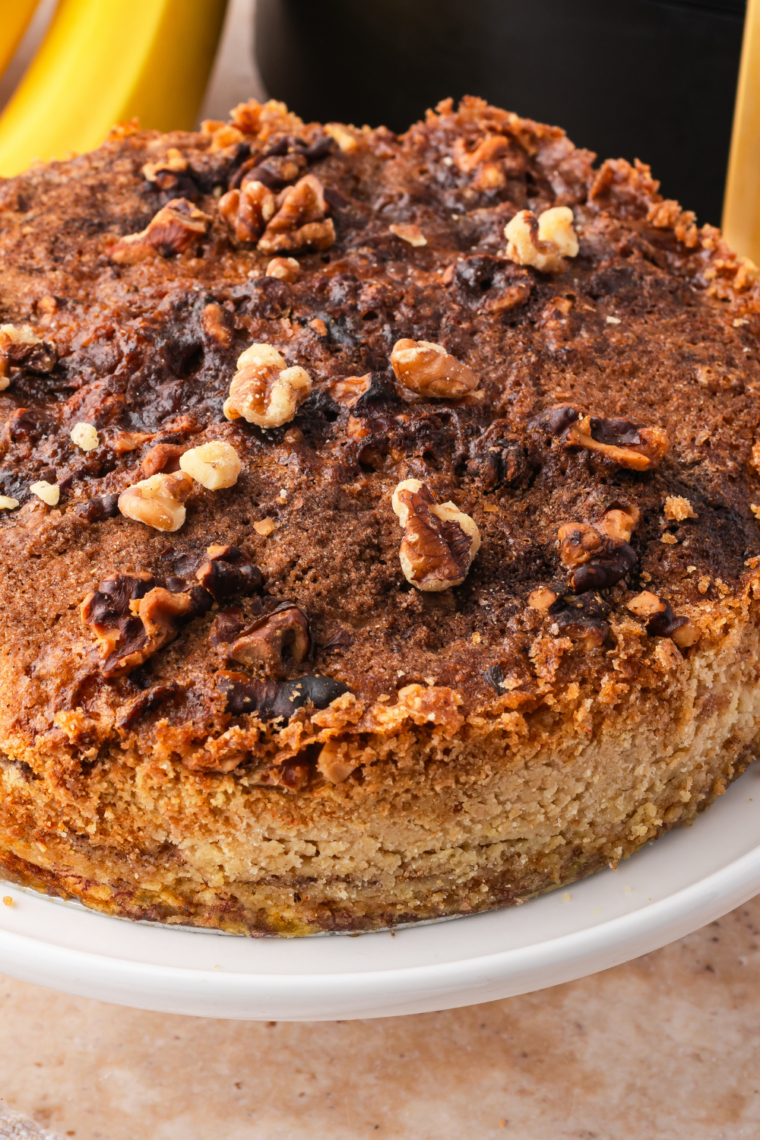 Round air fryer gluten-free banana bread served on a white plate