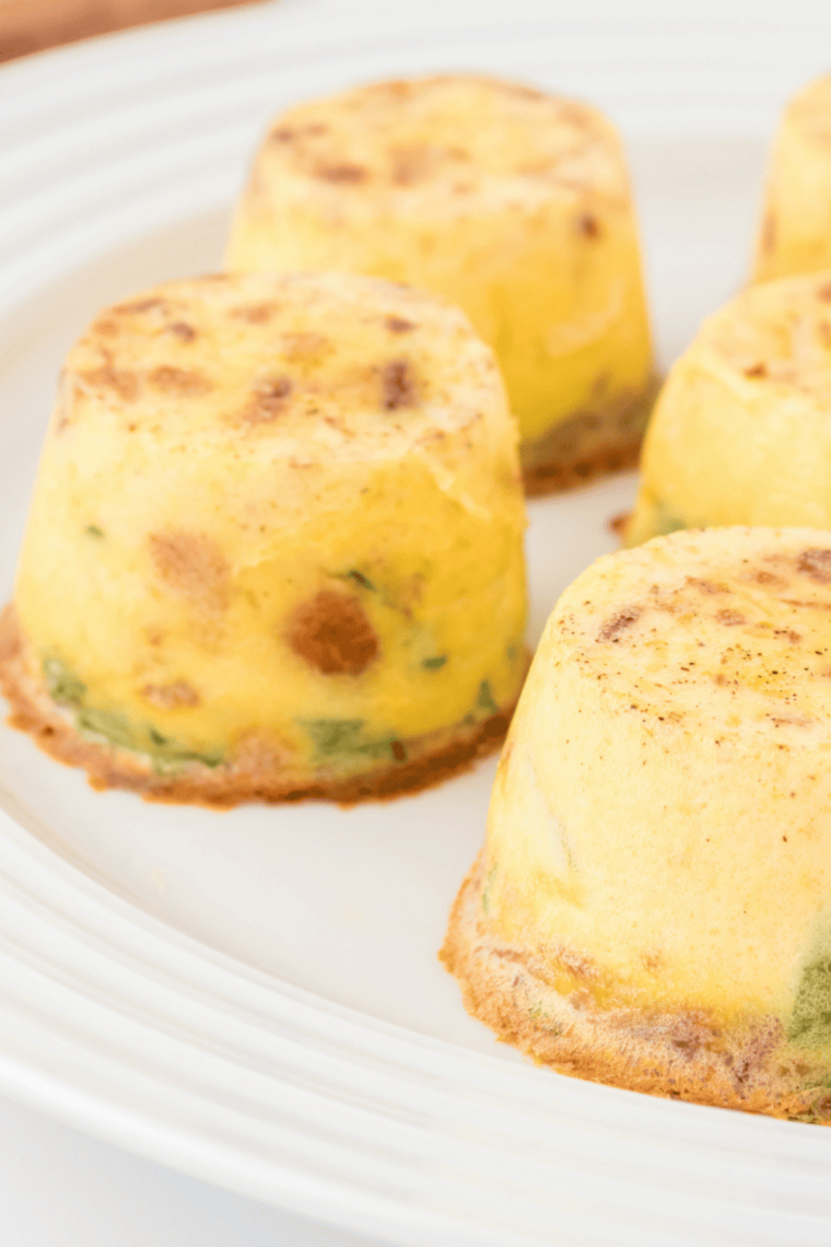 Air fryer truffle, mushroom, and brie egg bites in a small serving dish, golden and fluffy