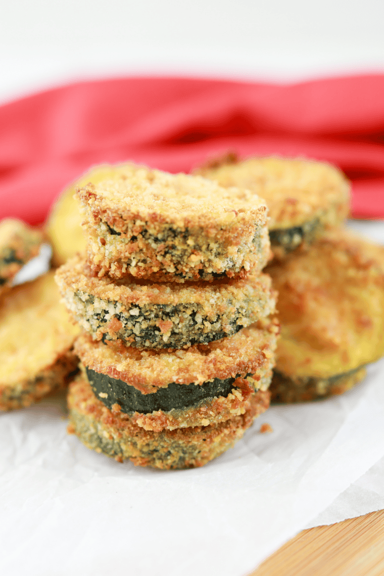 Crispy golden copycat Carl’s Jr. fried zucchini sticks served on a plate with dipping sauce.