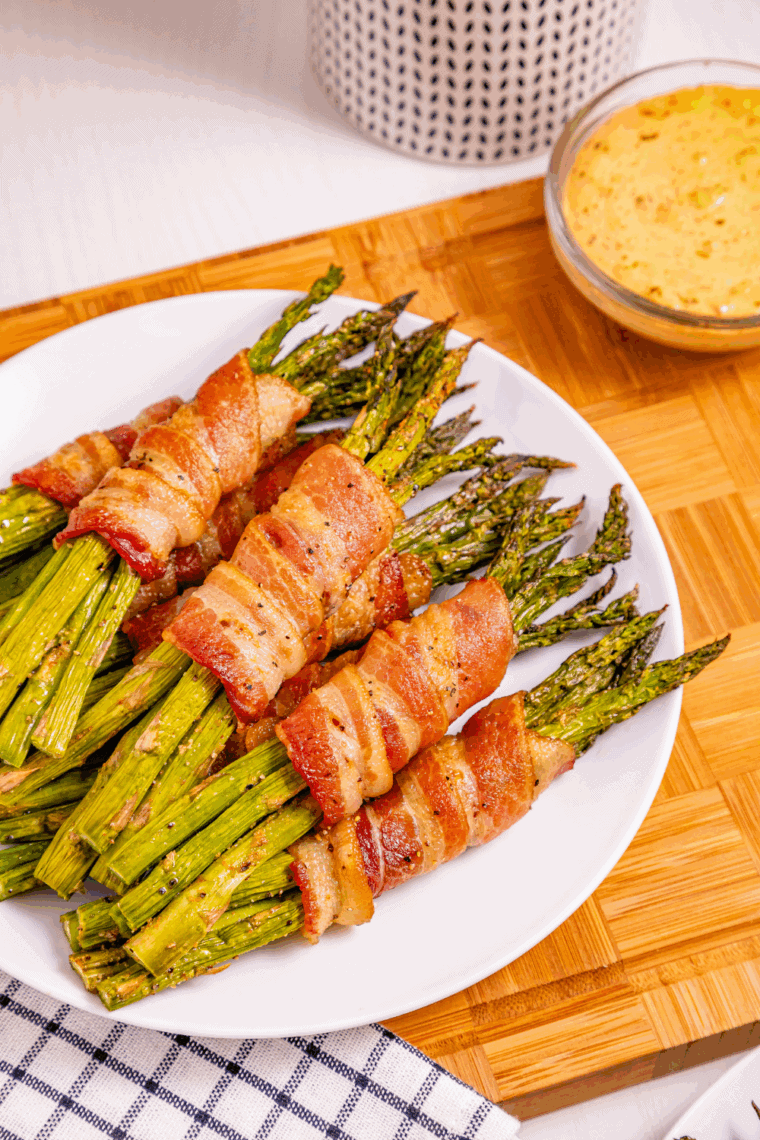 Golden bacon wrapped asparagus cooking in the air fryer
