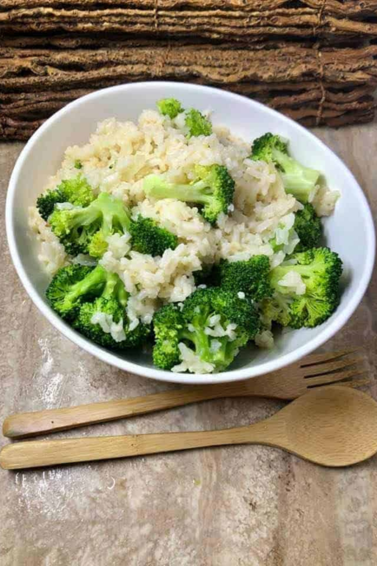 "Bowl of Instant Pot Cheesy Broccoli and Rice garnished with fresh parsley."