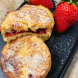 Jam stuffed French toast coated in sugar with raspberry jam showing through the center