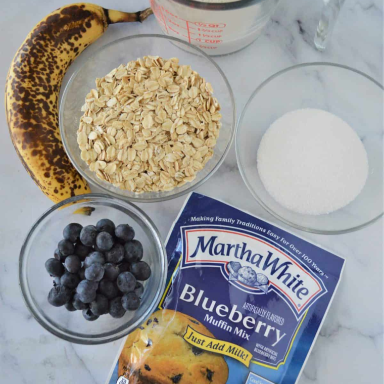 Ingredients needed for Air Fryer Banana Blueberry Oatmeal Muffins on kitchen table.